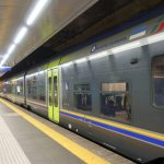 Naples Metro underground station with train leaving platform, Italy