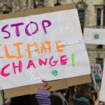 Protestors holding climate change banners at a protest